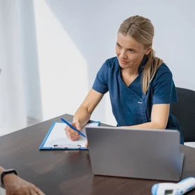 A doctor completing a medical report
