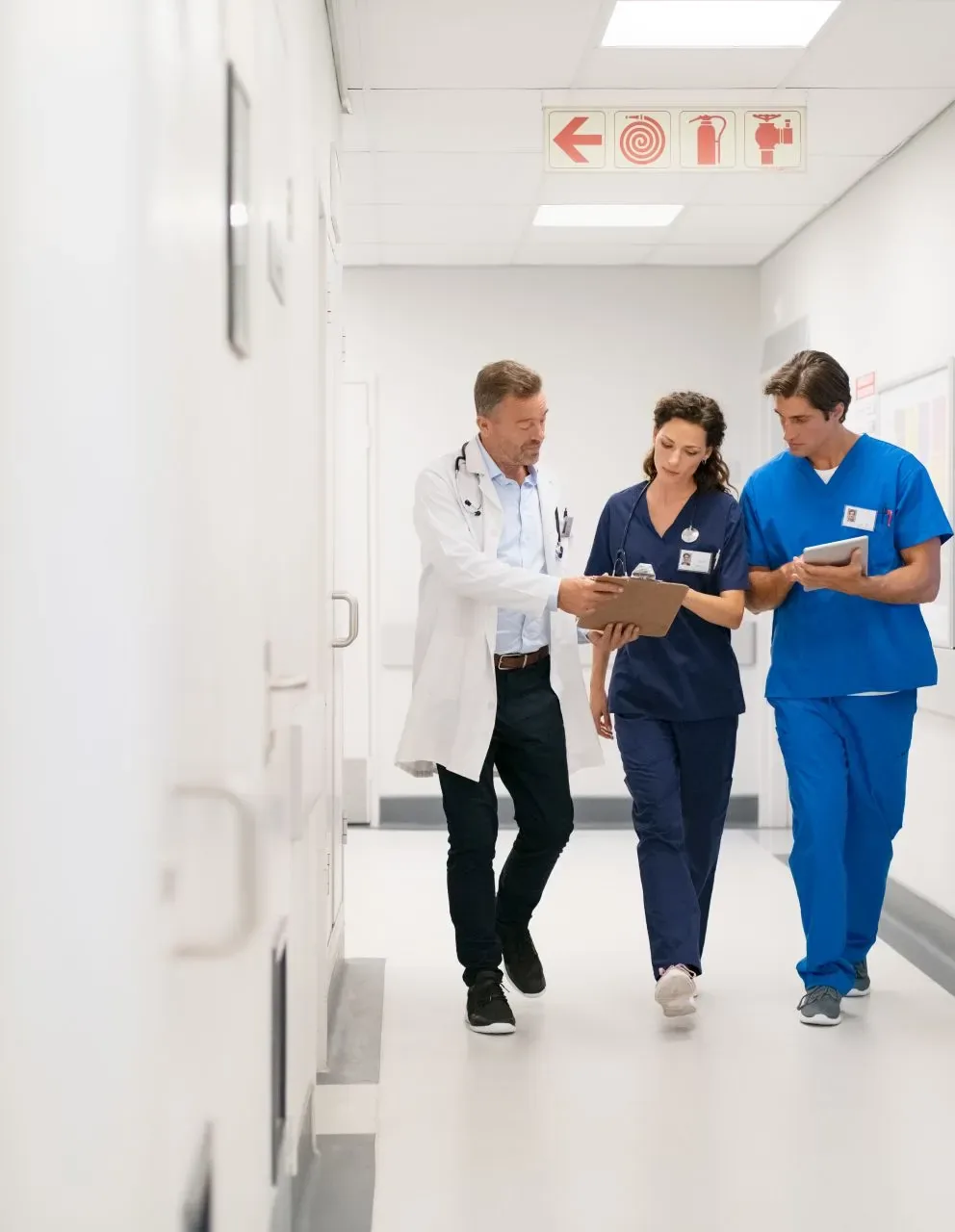 Medical staff discussing a report at the hospital