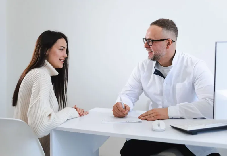 A doctor writing a prescription for a patient