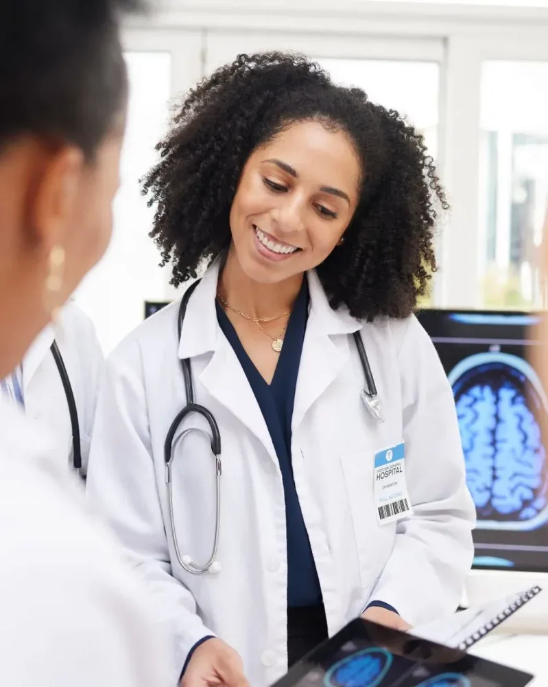 A doctor reviewing a brain scan on a tablet